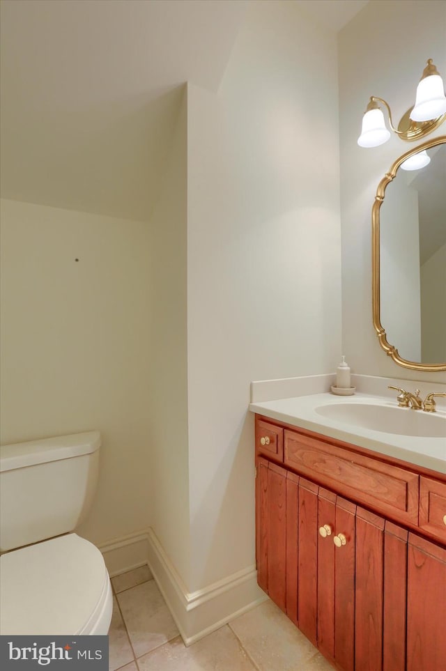 bathroom with tile patterned flooring, vanity, and toilet