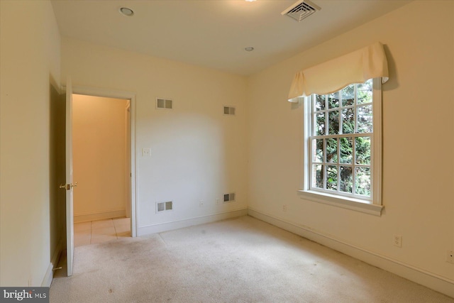 unfurnished room with light carpet and a healthy amount of sunlight