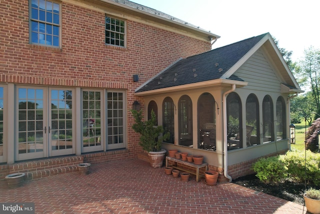 back of property featuring french doors, a patio area, and a sunroom