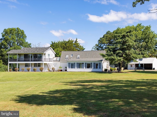 back of house featuring a lawn