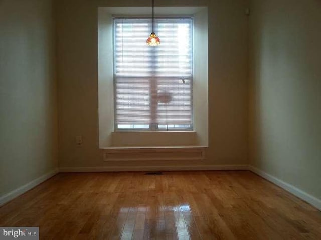 unfurnished dining area featuring hardwood / wood-style floors