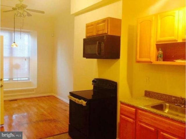 kitchen with sink, ceiling fan, and black appliances