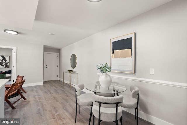 dining space with light hardwood / wood-style flooring