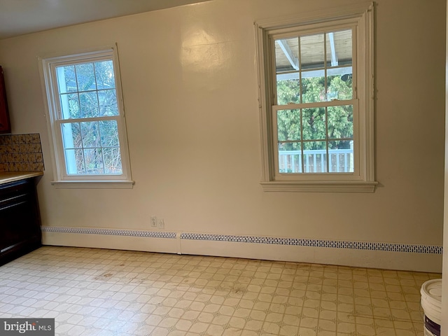 unfurnished dining area with baseboard heating and plenty of natural light