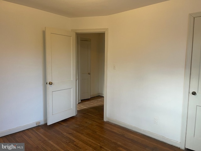 spare room featuring dark hardwood / wood-style floors