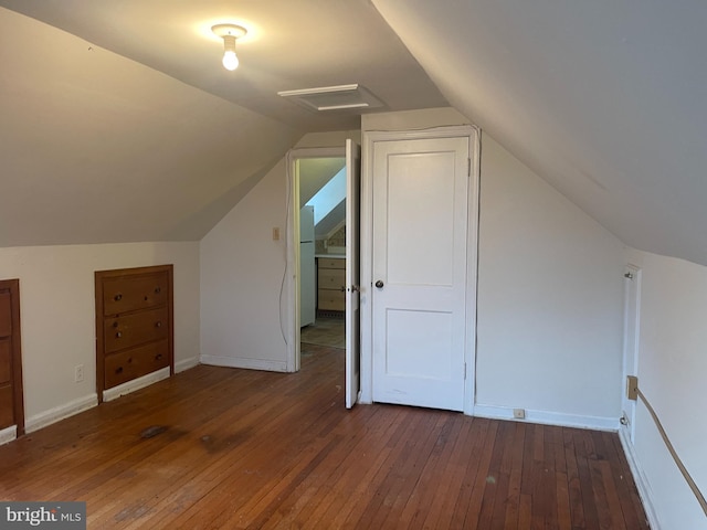 additional living space with dark hardwood / wood-style flooring and lofted ceiling