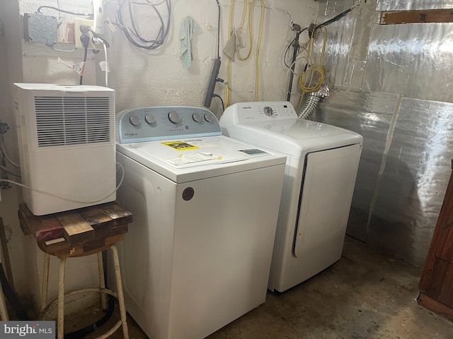 clothes washing area with separate washer and dryer