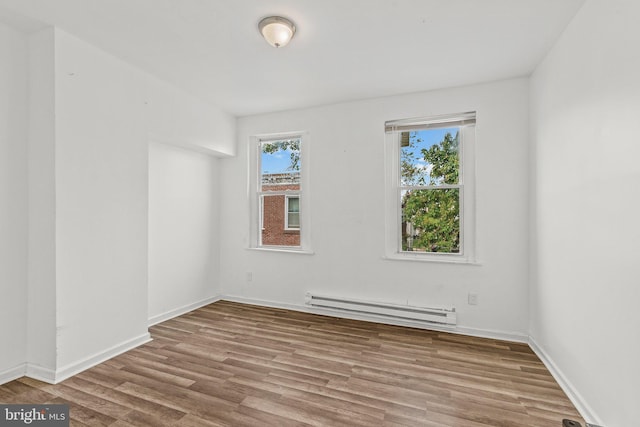 spare room with light hardwood / wood-style floors and baseboard heating