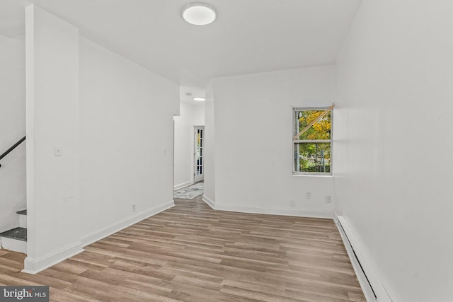 spare room featuring light hardwood / wood-style flooring and a baseboard radiator