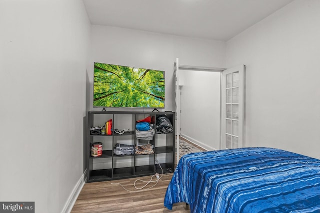 bedroom with hardwood / wood-style floors