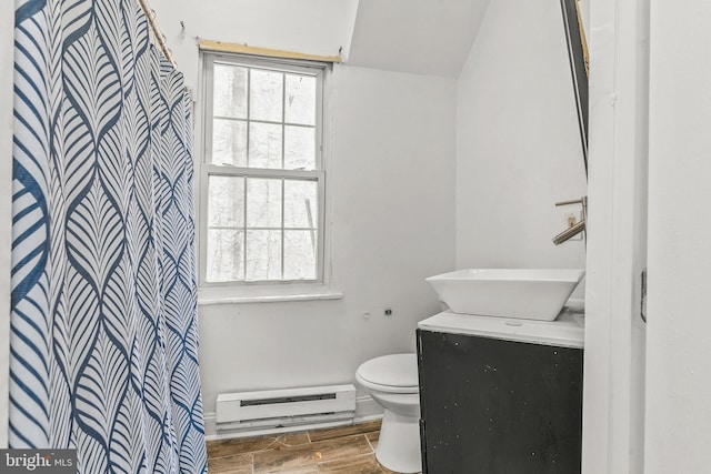 bathroom with vanity, toilet, and a baseboard heating unit