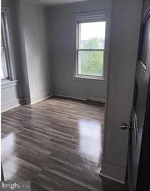 spare room with dark hardwood / wood-style floors