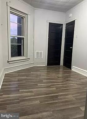 unfurnished room featuring dark hardwood / wood-style floors