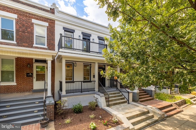 view of front of house featuring a balcony and a porch