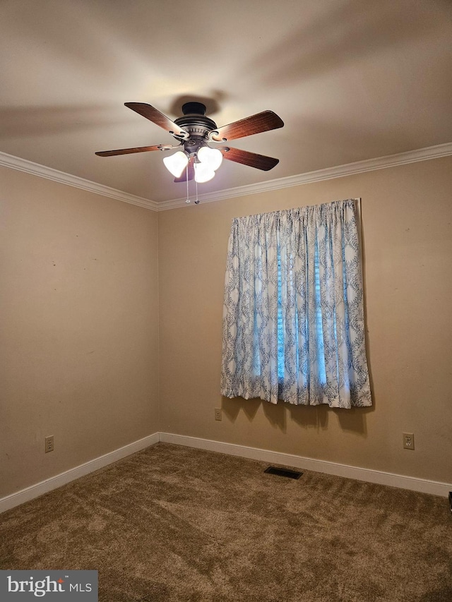 carpeted spare room featuring crown molding and ceiling fan