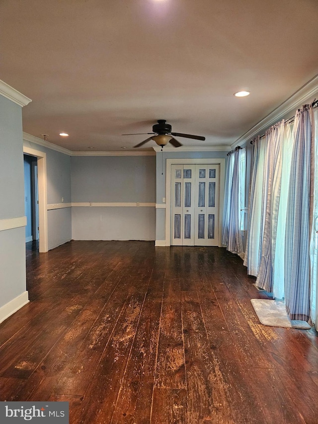 unfurnished room featuring crown molding, dark wood-type flooring, and ceiling fan