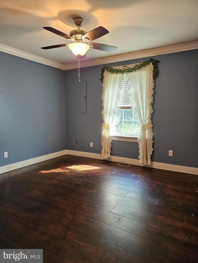 empty room with hardwood / wood-style flooring, crown molding, and ceiling fan