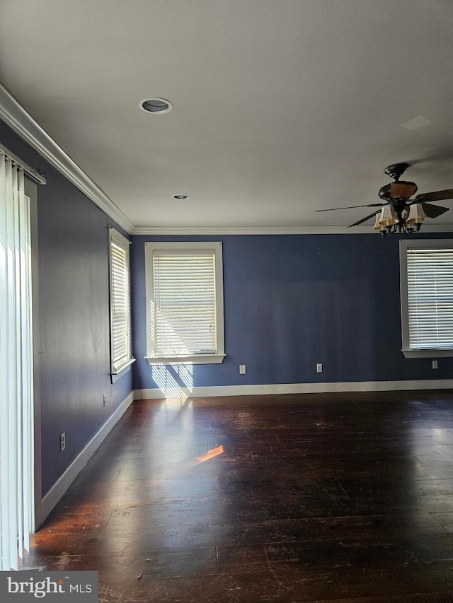 unfurnished room featuring crown molding, dark wood-type flooring, and ceiling fan