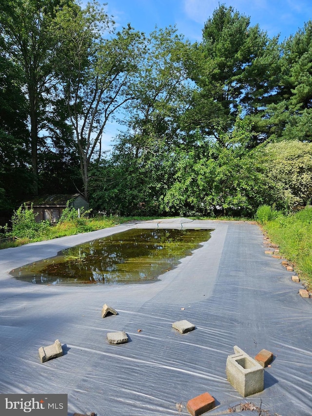 view of swimming pool featuring a water view