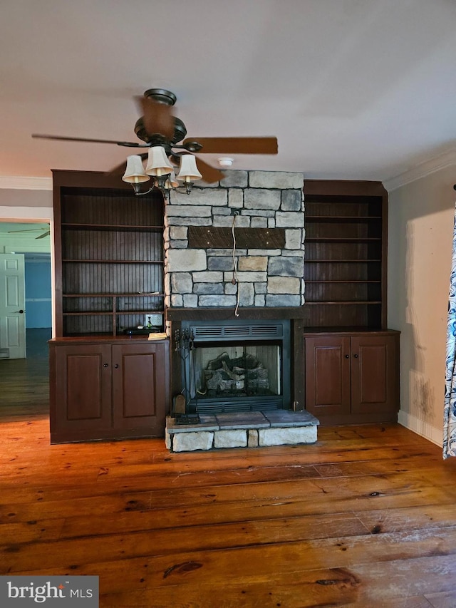 interior details with crown molding, ceiling fan, a fireplace, and hardwood / wood-style floors