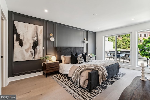 bedroom with access to outside and light wood-type flooring