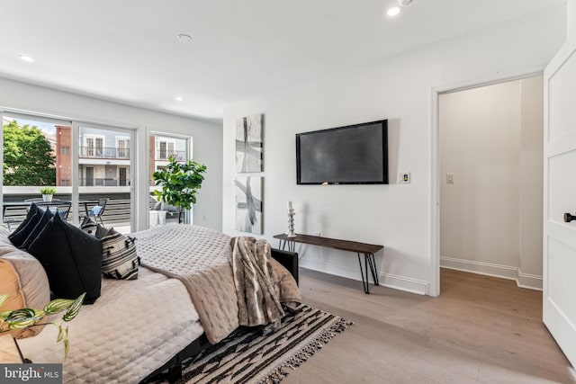 bedroom featuring access to outside and light wood-type flooring