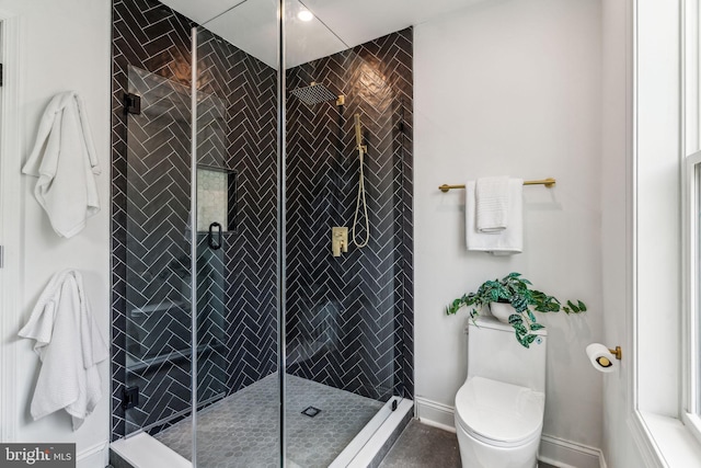 bathroom with toilet and an enclosed shower