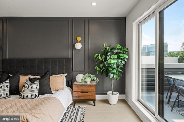 bedroom with access to exterior and light wood-type flooring