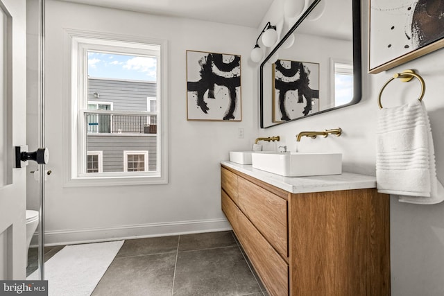 bathroom featuring vanity, toilet, and tile patterned floors