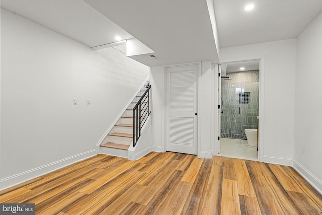 basement with light hardwood / wood-style floors