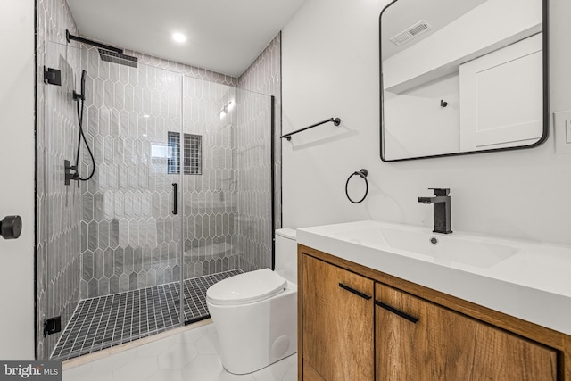 bathroom with vanity, an enclosed shower, toilet, and tile patterned floors