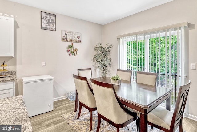 dining space featuring light hardwood / wood-style flooring