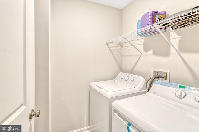 laundry area with washing machine and clothes dryer