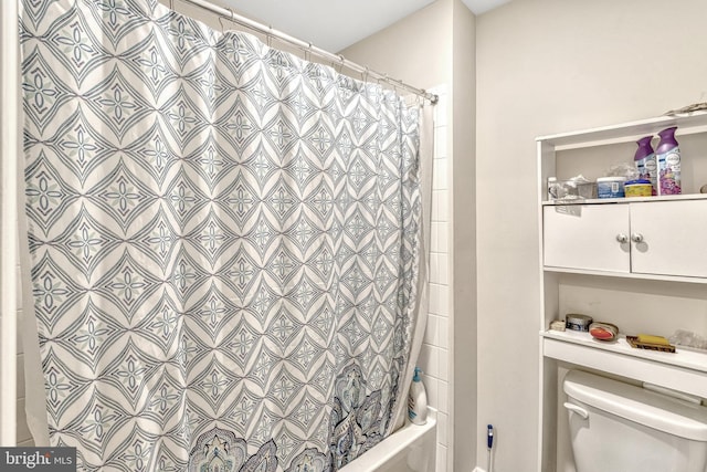 bathroom with toilet and shower / bath combo with shower curtain