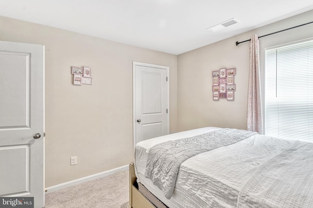 bedroom featuring light colored carpet