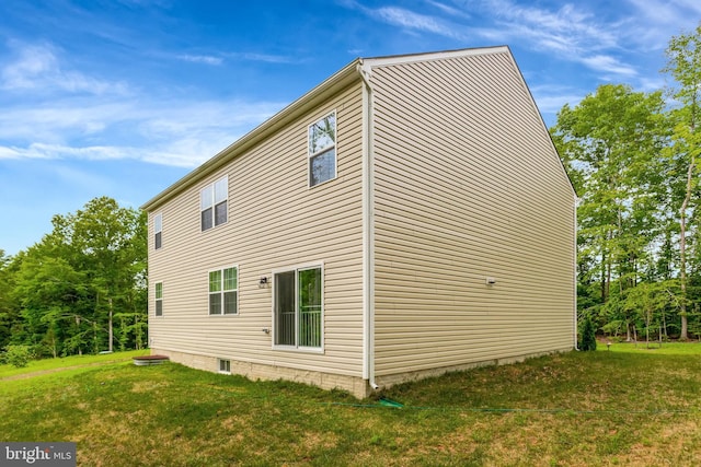 view of side of home with a lawn