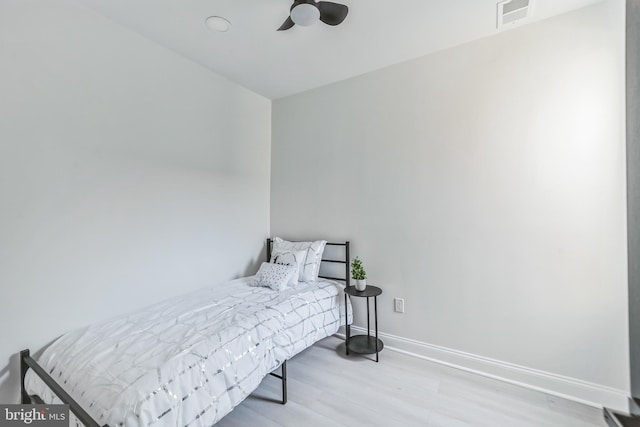 bedroom with light hardwood / wood-style flooring and ceiling fan