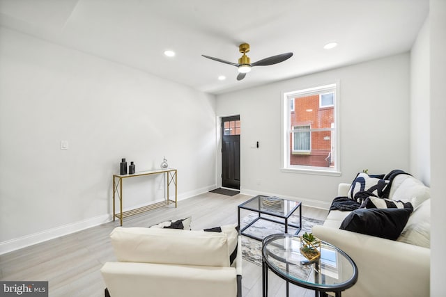 living room with ceiling fan and light hardwood / wood-style floors