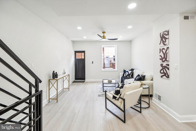 sitting room with ceiling fan and light hardwood / wood-style floors