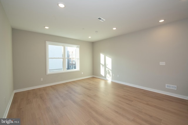 unfurnished room with light wood-type flooring