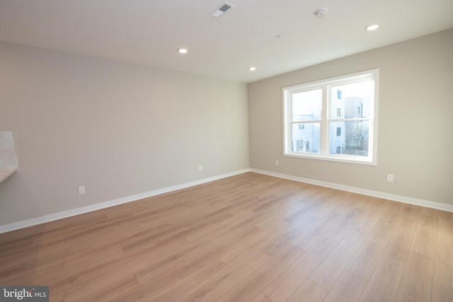 unfurnished room featuring light wood-type flooring