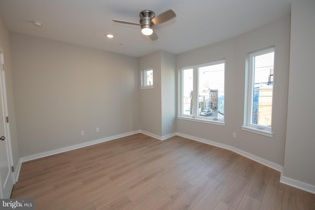 unfurnished room featuring light hardwood / wood-style flooring and ceiling fan