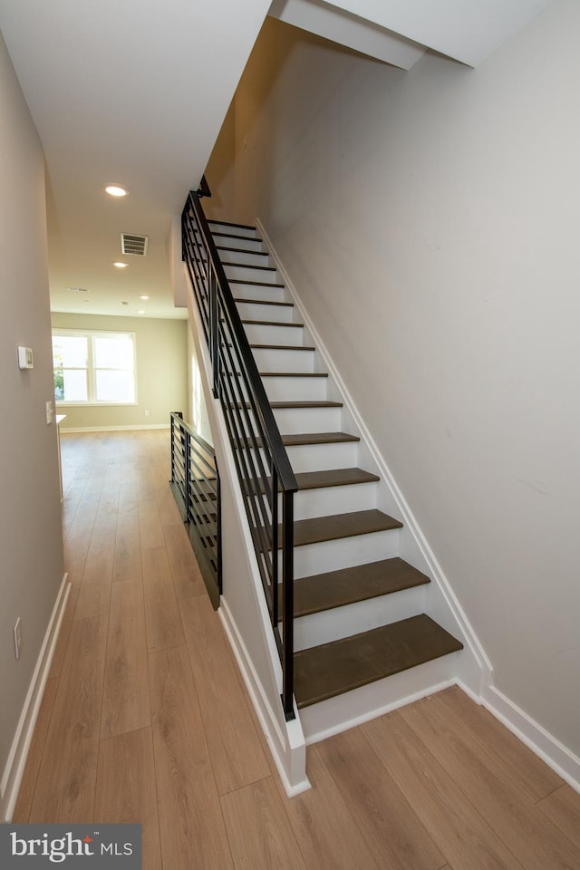 stairway featuring hardwood / wood-style flooring