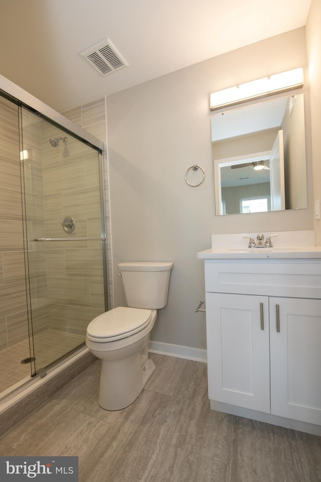 bathroom with vanity, an enclosed shower, hardwood / wood-style floors, and toilet