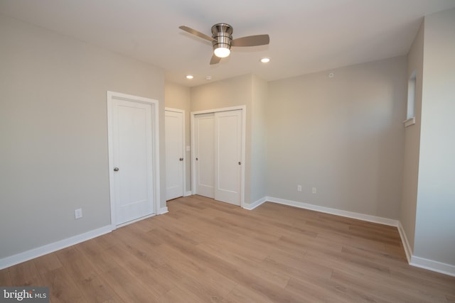 unfurnished bedroom featuring ceiling fan and light hardwood / wood-style floors