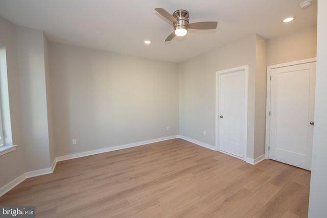 unfurnished room featuring ceiling fan and light wood-type flooring