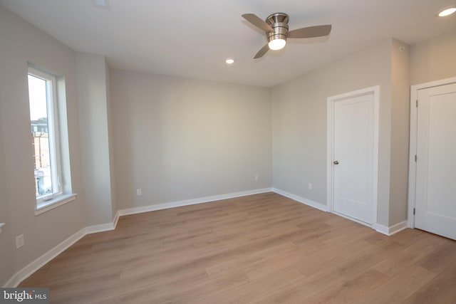 empty room featuring ceiling fan and light hardwood / wood-style flooring