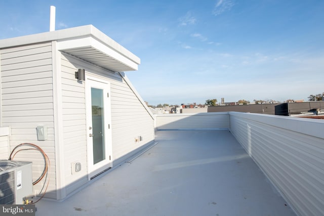 view of patio featuring central AC unit and a balcony