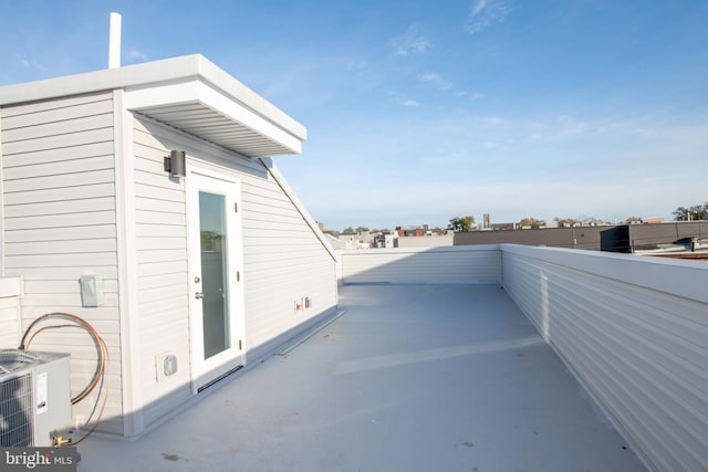 view of patio featuring central AC and a balcony