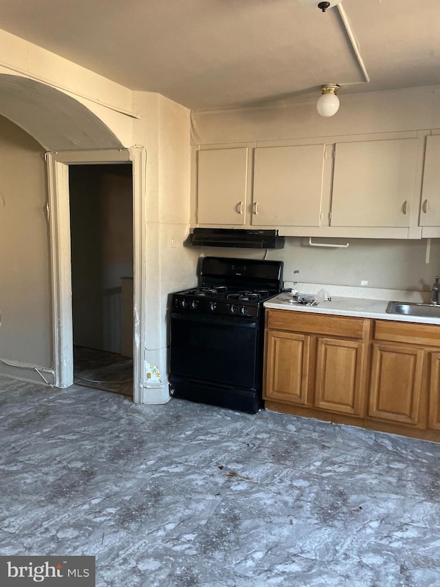 kitchen featuring sink, white cabinetry, and black range with gas stovetop